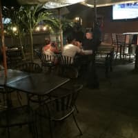 <p>Patrons of 381 Main Street Bar and Grill in Little Falls, N.J., can dine under the palms outdoors and still catch the game on TV.</p>