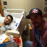 <p>Selwyn Torres recovers at Morristown Medical Center with his brother, Xavier Martinez.</p>