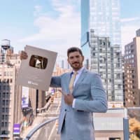 <p>Conover and his YouTube Creator Award for surpassing one million subscribers</p>