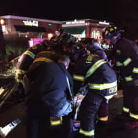 <p>Members of the Fairfield Fire Department work to free a trapped woman.</p>