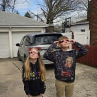 <p>Alice and Oliver, of Lodi, watch the eclipse with glasses they bought last minute.</p>
