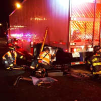 <p>Westport firefighters work to free a van that was under a tractor-trailer.</p>