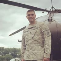 <p>U.S. National Guard Black Hawk pilot and Paramus police officer Matt Lombardo after landing a military helicopter in the borough on National Night Out.</p>