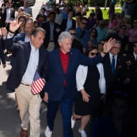 <p>Cuomo marches alongside former President Bill Clinton and former Secretary of State Hillary Clinton in the New Castle Memorial Day Parade on Monday, May 27.</p>