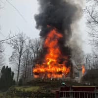 <p>Flames quickly engulfed the Wayne home.</p>