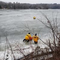 <p>Members of the Stevenson Volunteer Fire Department work to save a deer trapped on ice.</p>