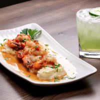 <p>Wild caught jumbo shrimp over cauliflower mash and Albariño cherry pepper reduction sauce and jalapeno infused cucumber margarita at Tequila Escape Kitchen + Cocktail Bar in Ridgefield.</p>