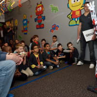 <p>Children interact with an intelligent robot built from durable plastic pieces that moves and speaks.</p>