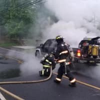 <p>Westport firefighters douse the flames.</p>