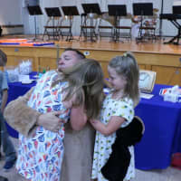 <p>Orange County Executive Steve Neuhaus surprising children at a school assembly.</p>