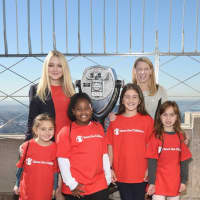 <p>Actress Dakota Fanning, back left, and Save the Children President &amp; CEO Carolyn Miles join (from left) Colette Prainito, Miracle Jones, Kate Papadatos and Antonella Garcia atop the Empire State Building.</p>