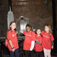 <p>From left: Kate Papadatos of Norwalk, Miracle Jones of Blackville, S.C., Colette Prainito of Farmingville, N.Y., and Antonella Garcia of Basking Ridge, N.J., help to light up the Empire State Building.</p>