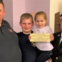 <p>Left to right: Michael McLaughlin&#x27;s son, Kevin, who is now a Norwood fire chief, grandson Kevin, granddaughter Lucy, Ridgefield Fire Chief Michael Kees.</p>