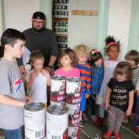<p>Student Ronan Moran, left, explains Food Bowl to a group of younger students.</p>