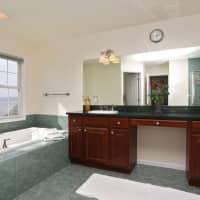 <p>The master bathroom includes marble countertops and a view of the Marina.</p>