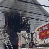 <p>Bayonne firefighters rescue residents from the second floor of the E. 16th Street house.</p>