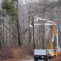 <p>United Illuminating crew works to restore power near Clark Road. in Woodbridge, on Friday, Dec. 23, an outage that affected 1,200 customers after a tree fell on electrical wires.</p>