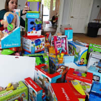 <p>A volunteer prepares the infant and toddler toys for the 2015 event.</p>
