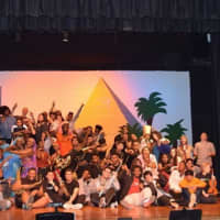 <p>The whole crew and cast of &quot;Aida&quot; get together on stage at Spring Valley High School.</p>