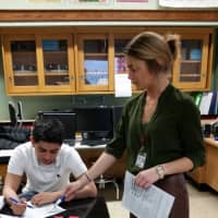 <p>Following her presentation, Annelise Quinn, clinical dietician at White Plains Hospital, reviews a nutrition label worksheet with a student.</p>