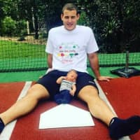 <p>Anthony Rizzo with his nephew. Rizzo is wearing a Lyndhurst Pastry Shop t-shirt.</p>