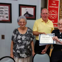 <p>County Clerk John Hogan, a former Northvale mayor, presents a certificate of appreciation to Artie Bodrato recognizing 70 years service in the Fire Department.</p>