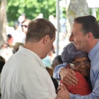 <p>Rob Astornio hugs one of the guests at the Westchester annual senior pool party/barbeque in White Plains.</p>