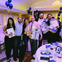<p>Auction winners with prizes from Holiday Inn Hasbrouck Heights, Cookies by Design in Englewood, the county Department for Persons with Disabilities and GNC.</p>