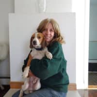 <p>Ellen Ribitzki holds a dog available for adoption while sitting in the living room of the Bloomingdale Regional Animal Shelter Society&#x27;s new home in Ringwood.</p>