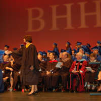 <p>Board of Education President Robin Glat congratulates graduates during the Byram Hills High School Commencement, held Tuesday at Purchase College.</p>