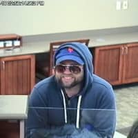 <p>Police released surveillance photos of the suspect in the robbery of Union Savings Bank on North Street in Danbury.</p>