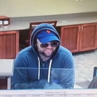<p>Police released surveillance photos of the suspect in the robbery of Union Savings Bank on North Street in Danbury.</p>