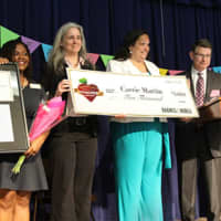 <p>Carrie Martin, second from right, is presented with a check by Barnes &amp; Noble officials after being named National Teacher of the Year for 2015-2016. Martin teaches second grade at the Evers Park Elementary School in Denton, Texas,  .</p>