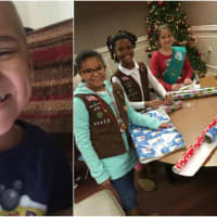 <p>Hackensack Girl Scouts and Daisies wrap gifts for Lil Ryu at the South Hackensack fire department.</p>