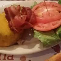 <p>The Blazer Pub&#x27;s signature round and juicy beef patty is draped in melted cheese and topped with bacon, tomato and lettuce.</p>