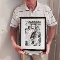 <p>Bob Skead with an illustration from one of the books.</p>