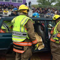 <p>Members of the Bogota Rescue Squad attempting to remove passengers from the vehicle</p>