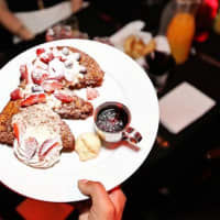 <p>The French toast is smothered in whipped cream and strawberries at Bottagra&#x27;s adults-only, once-a-month brunch in Hawthorne.</p>
