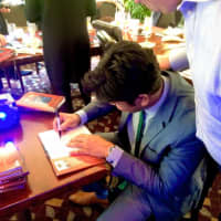 <p>Richard Etwaru signs copies of his book &quot;Corporate Awesome Sauce.&quot;</p>
