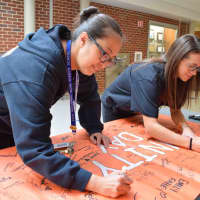 <p>Croton-Harmon High School students signed an anti-bullying pledge on Unity Day and donned orange bracelets reading “Croton Unites” to send an anti-bullying message.</p>