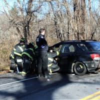 <p>Emergency responders swarm around one of the vehicles involved in the crash.</p>