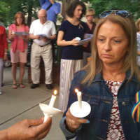 <p>Mourners helped light each other&#x27;s candles</p>