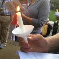 <p>Mourners held burning candles while singing songs and reciting prayers</p>