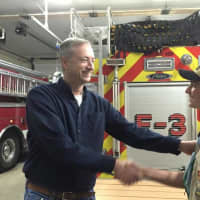 <p>Casey Meskers thanking Eagle Scout Michael Waugh for building two picnic tables for Easton Volunteer Fire Company.</p>