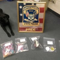 <p>State Police K-9 officer Favor with the drugs seized in a bust during a motor vehicle stop on I-84 in Danbury.</p>