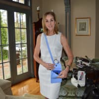 <p>Cathy Zahn of Franklin Lakes poses with one of her bags.</p>