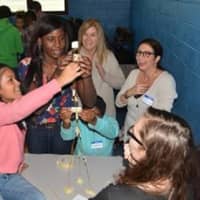 <p>Students and mentors met for the first time at Poughkeepsie High School earlier this month and were challenged with an engineering task. Mentors from Central Hudson, Jill Sammon and Diane D’Alessandro, encourage the students during the challenge.</p>