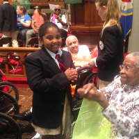<p>A member of the Chapel School Choir chats with a Wartburg Adult Care Community resident.</p>