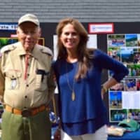 <p>Assistant District Commissioner Chick Scriber and ASMT President Leslie Pennington pose in front of a display of Darien Boy Scout history</p>