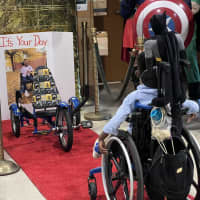 <p>Benjamin Brunson gets his first look at his Batman-theme accessibility tricycle, easily the best Batmobile ever constructed. The second grader is a big fan of the Caped Crusader.</p>